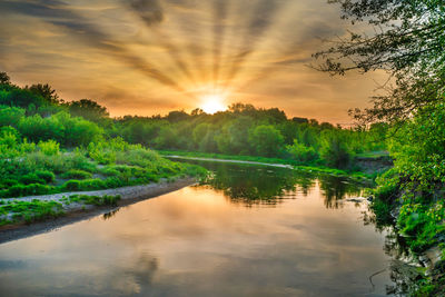 Scenic view of lake against sky during sunset
