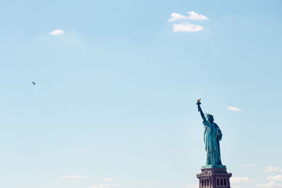 Low angle view of statue against cloudy sky