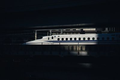 Train on building against sky at night