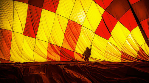 Silhouette people in hot air balloon