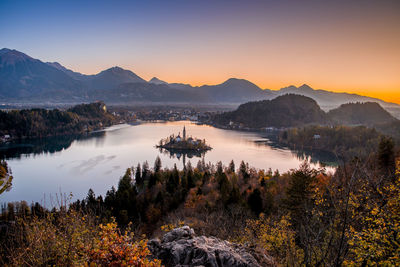 Scenic view of lake against sky during sunset