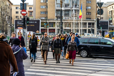 Group of people walking on city street