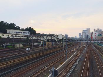 Railroad tracks amidst buildings in city