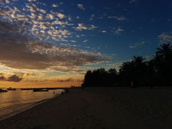 Scenic view of beach against sky during sunset