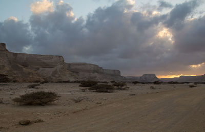 Scenic view of sand dunes against sky