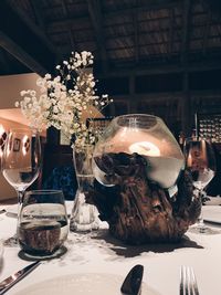 Close-up of glass vase on table in restaurant