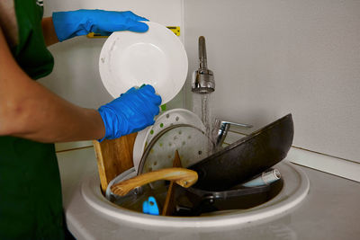 Midsection of woman washing dish