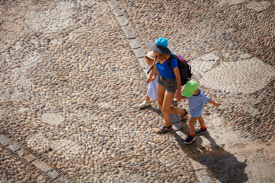 Rear view of people walking on street