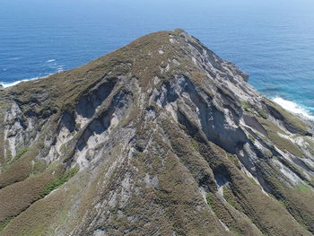 High angle view of rocks on beach against sky