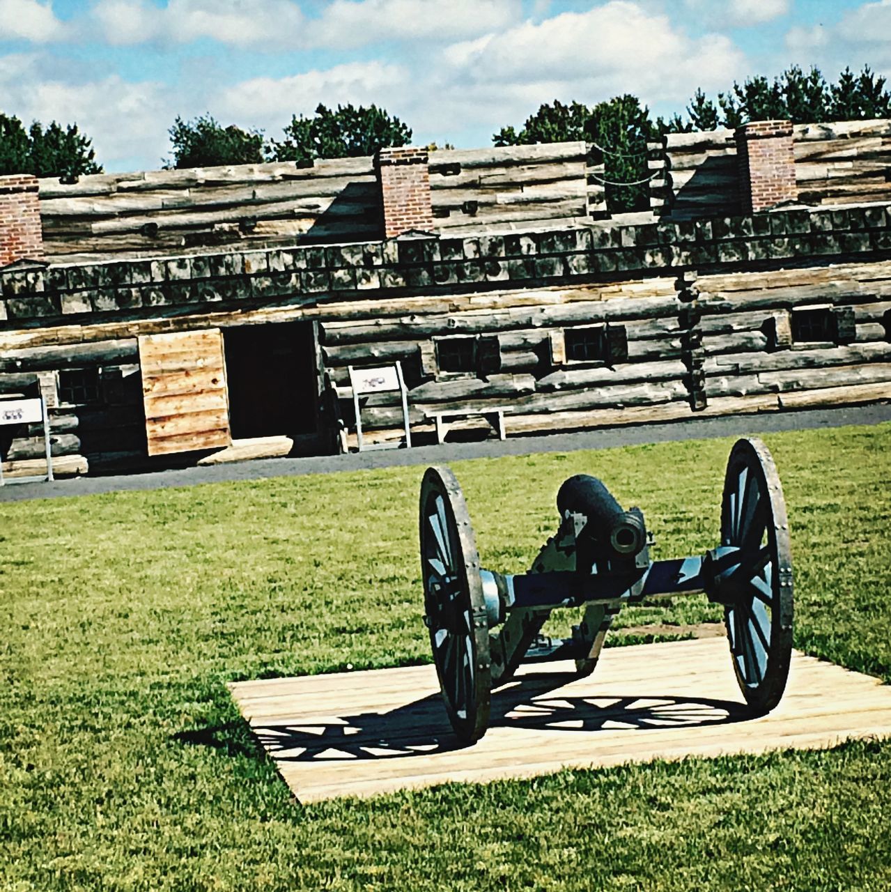 grass, grassy, field, lawn, sky, land vehicle, transportation, cloud - sky, shadow, bicycle, sunlight, green color, day, building exterior, built structure, landscape, outdoors, architecture, absence, park - man made space