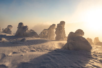 Scenic view of rocks against sky during sunset