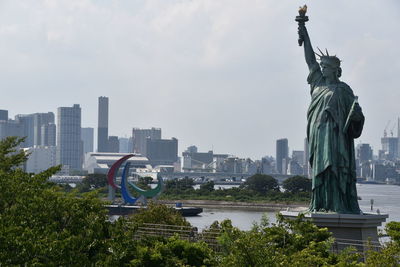 Statue of liberty against buildings in city