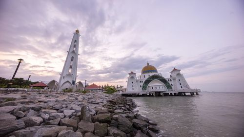 Built structures against cloudy sky