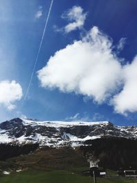 Scenic view of mountains against cloudy sky