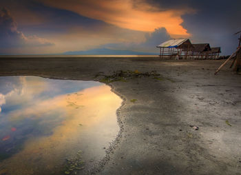 Scenic view of beach against sky during sunset