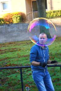 Side view of boy playing with bubbles