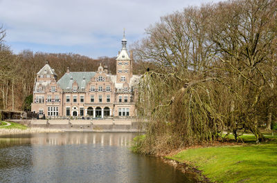 Historic duin en kruidberg mansion reflecting in nearby pond in kennemerduinen national park