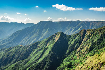 Misty mountain range covered with white mist and amazing blue sky