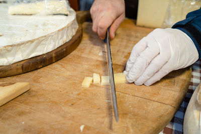 Midsection of person preparing food on cutting board