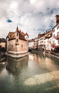 Canal amidst buildings in city