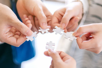 Hands holding jigsaw puzzle