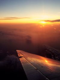 Cropped image of airplane flying over sea