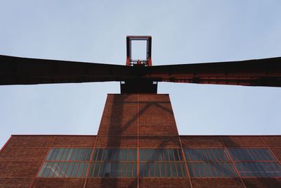 Low angle view of bridge against sky in city