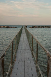 Pier over sea against sky