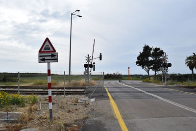 Road sign against sky