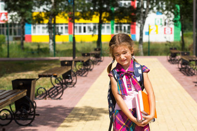 Portrait of smiling girl standing outdoors