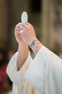 Cropped hands of priest performing ritual