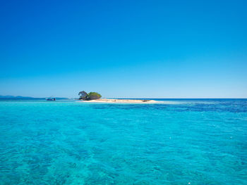 Scenic view of sea against clear blue sky