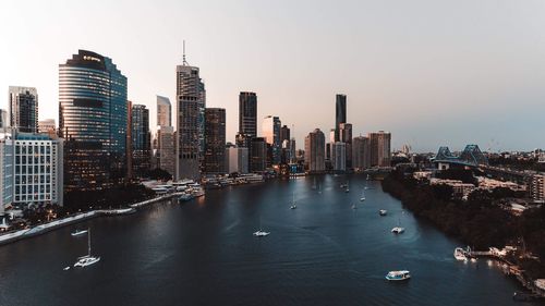 Aerial view of buildings in city against sky