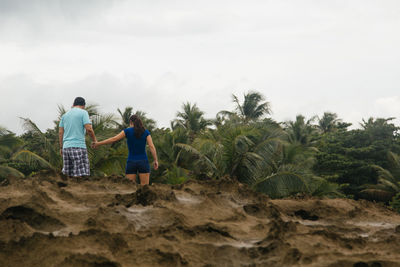 Full length of woman standing on tree trunk