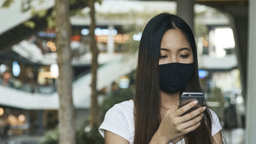 Portrait of woman holding mobile phone