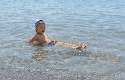 Portrait of boy swimming in sea