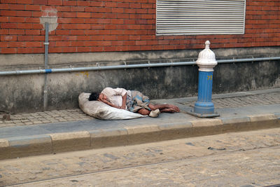 Man sleeping by the wall