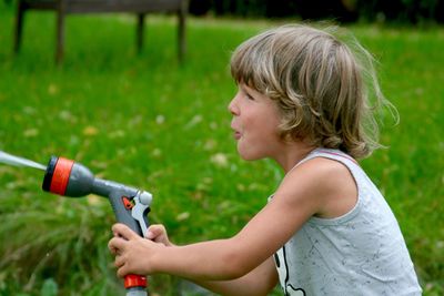 Playful boy holding squirt gun