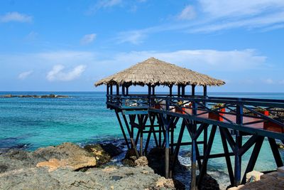 Lifeguard hut on beach against sky
