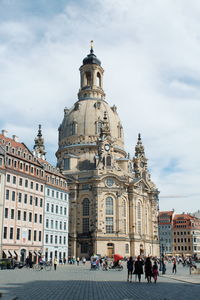 Group of people in front of building against sky