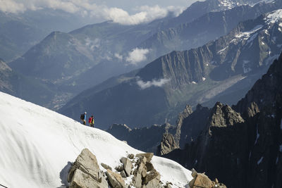 People hiking on snowcapped mountains