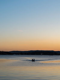 Scenic view of sea against clear sky during sunset