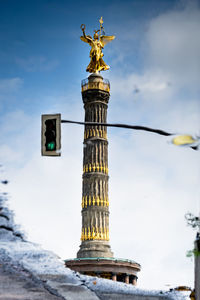 Low angle view of statue against cloudy sky