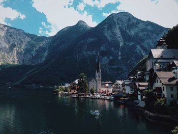 Buildings and mountain by lake at bad goisern am hallstattersee