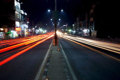 Light trails on road along buildings at night