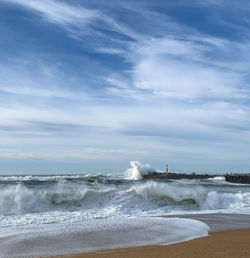Scenic view of sea against sky.  view from the beach of waves hitting the sand in a sunny winter day