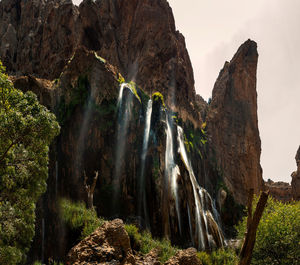 Low angle view of waterfall amidst rocks