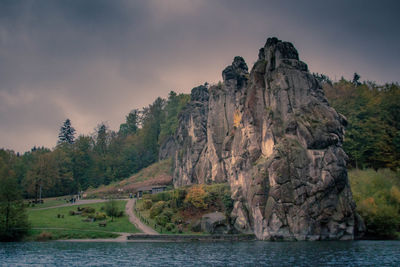 Rock formations by sea against sky