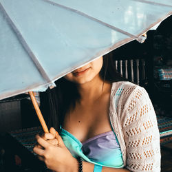 Young woman holding umbrella