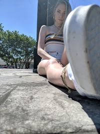 Midsection of woman sitting outdoors